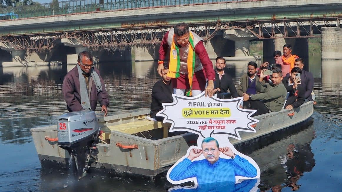 BJP’s Parvesh Verma Submerges Kejriwal’s Cut-Out In Yamuna Which Reads ‘I Have Failed, Don’t Vote For Me’
